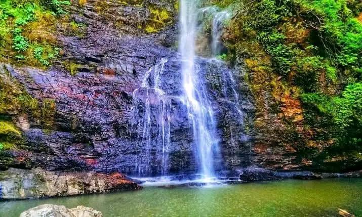 Majestic Owu Waterfall cascading down rocky cliffs, offering a peaceful wellness tourism experience in Nigeria