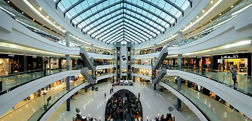 Shoppers exploring the vibrant Port Harcourt Mall with a mix of international and local stores.