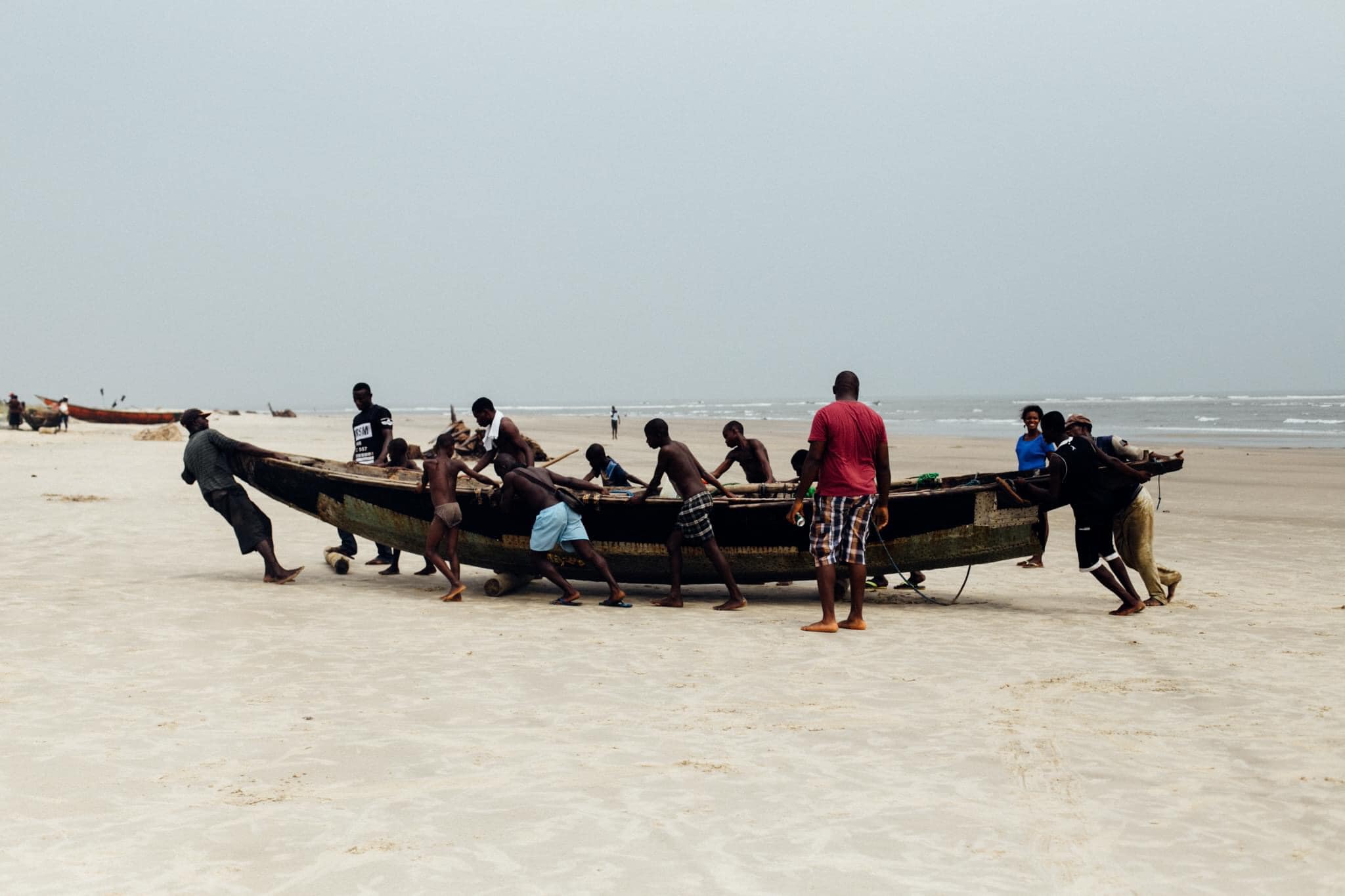 Andoni Island with the inhabitants towing a canoe. 
