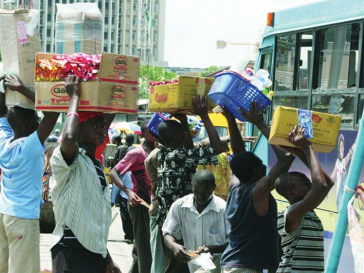  Picture of traders selling snacks on the road to people, adding to the cost of travel in Nigeria.
