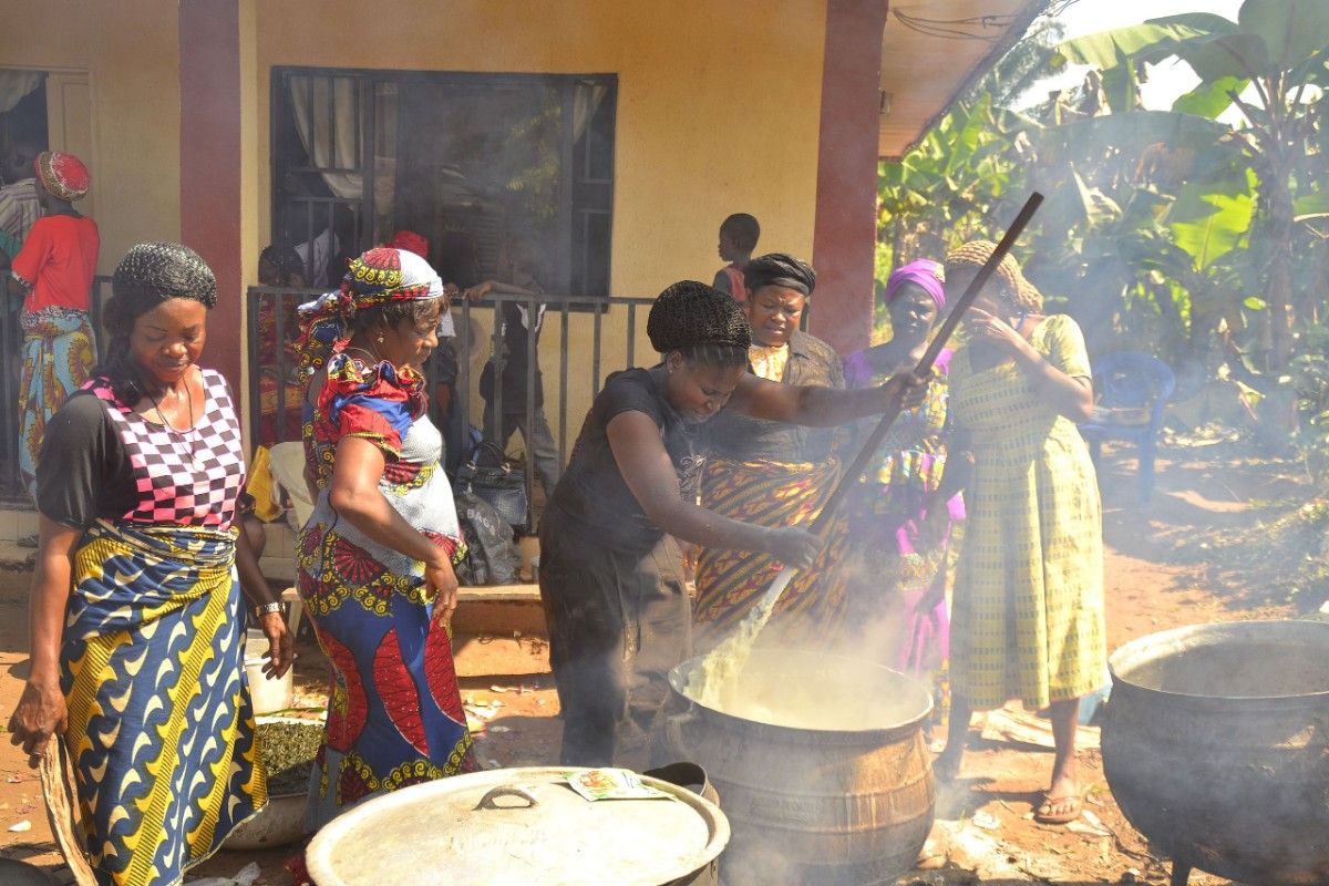  Nigerian women cooking together as a way to celebrate Christmas on a budget in Nigeria.