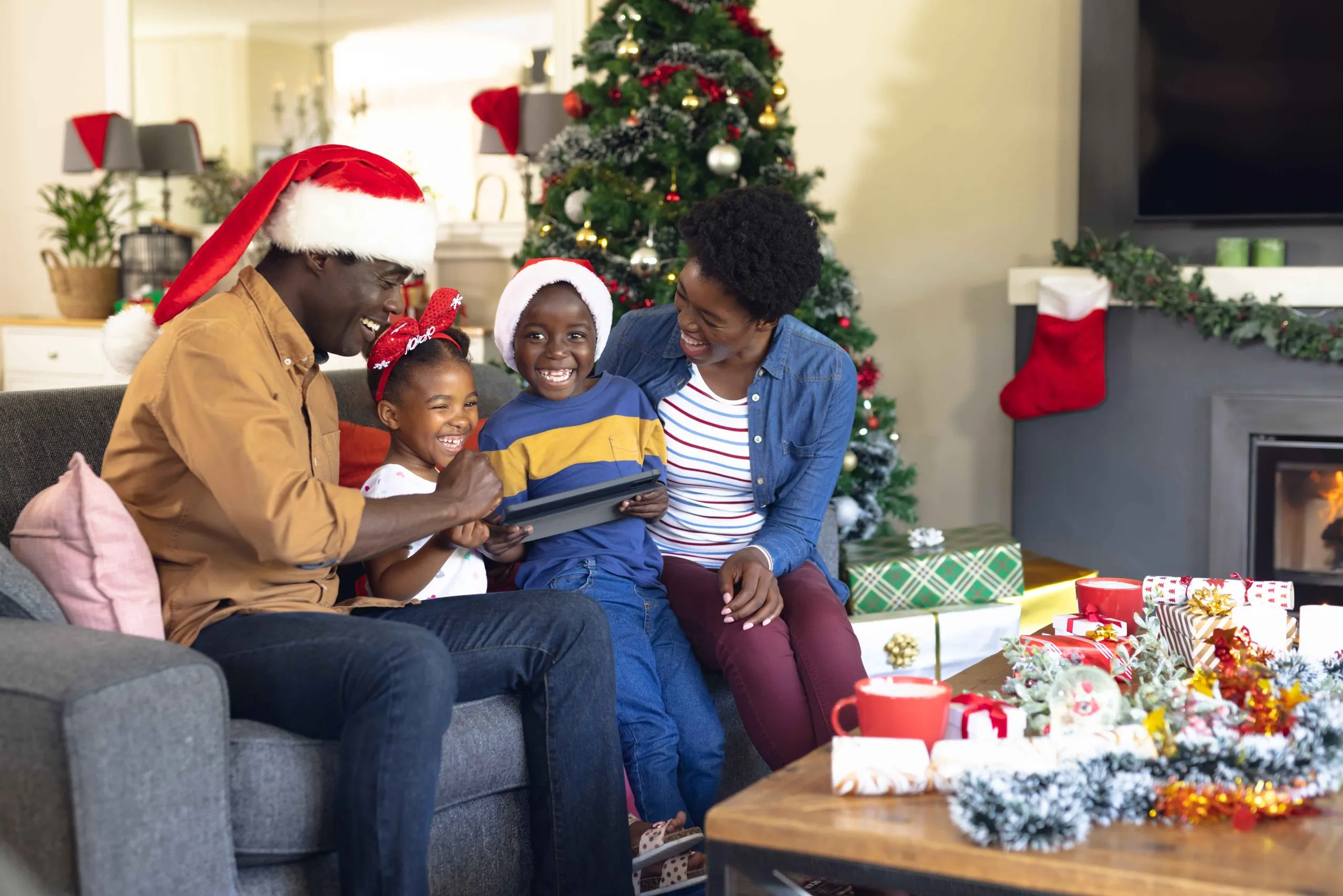  A happy family celebrating Christmas in their DIY decorated home as a way to celebrate Christmas on a budget in Nigeria.