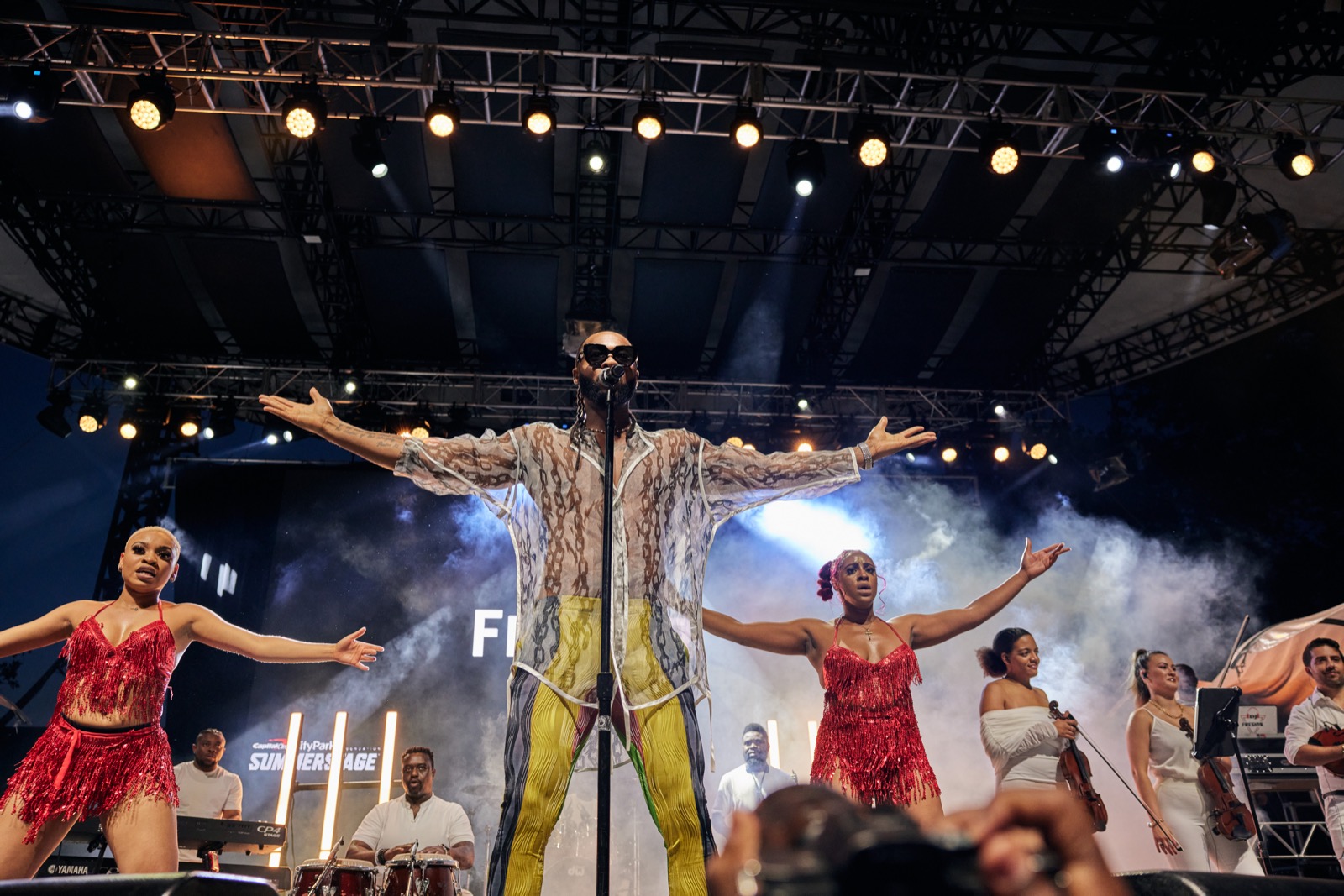 Flavour performing on stage during a Detty December concert

