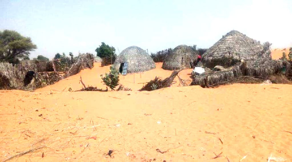 A picture of dry land and little huts in Kaska Village, Northern Nigeria.