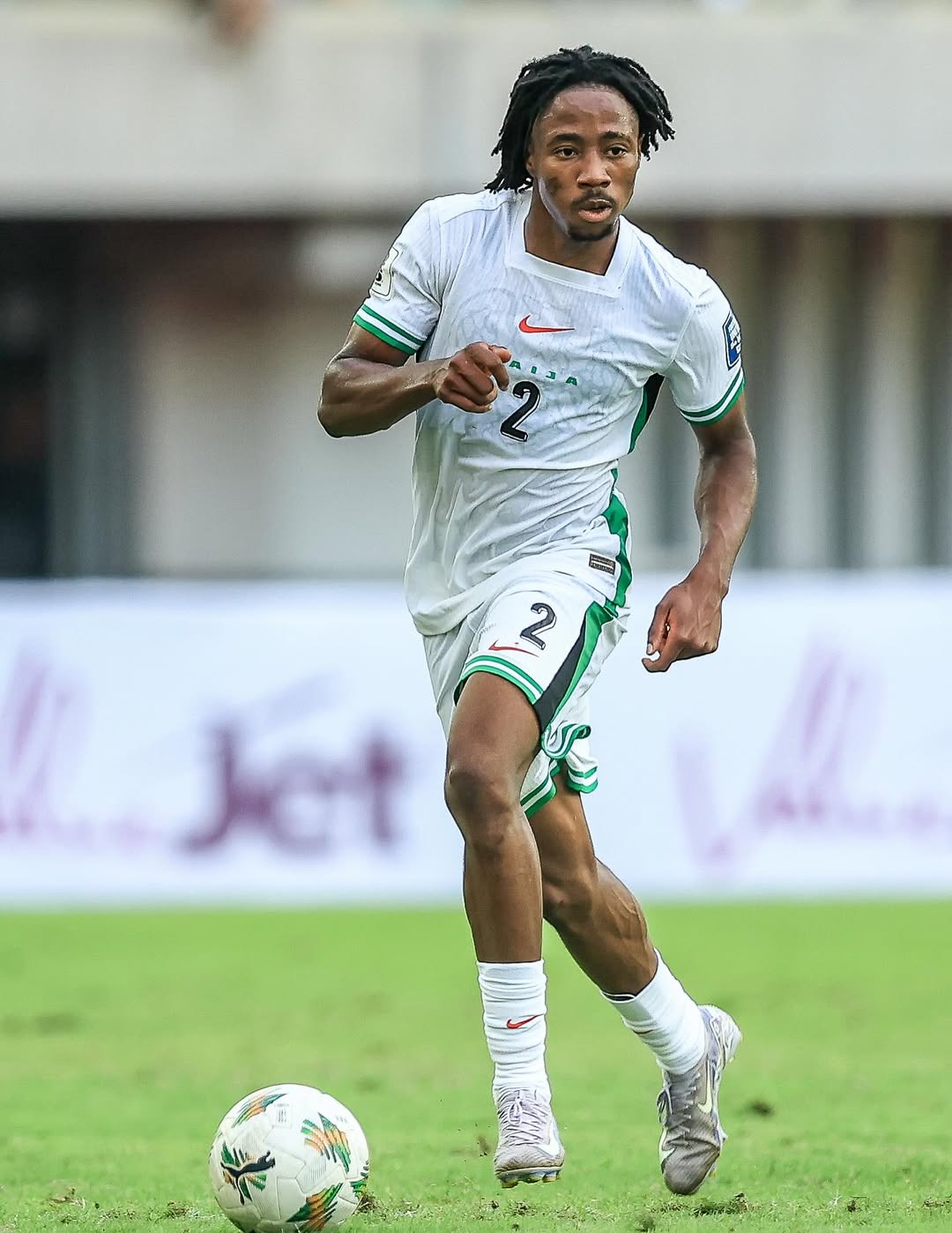 Benjamin Frederick in possession of the ball, wearing Nigeria's white away kit with number 2 during a World Cup qualifier

