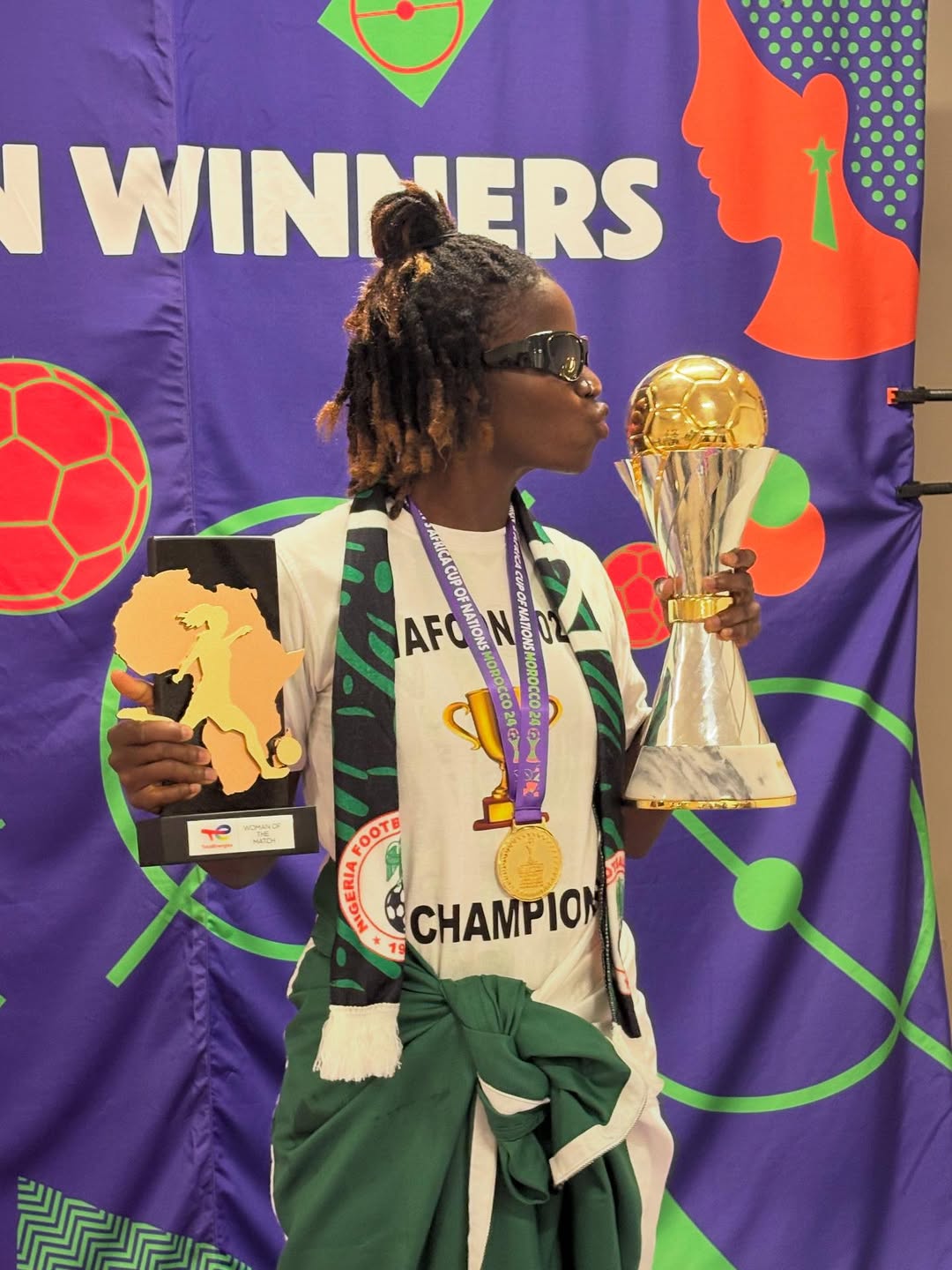 Esther Okonkwo celebrates winning WAFCON 2024 with championship trophy and Fan Player of the Tournament award
