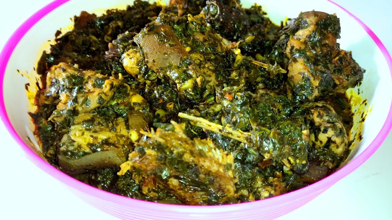 A picture of Editan soup with smoked fish and periwinkle, one of the local dishes to try in Akwa Ibom during the holidays, served in a home-style bowl.