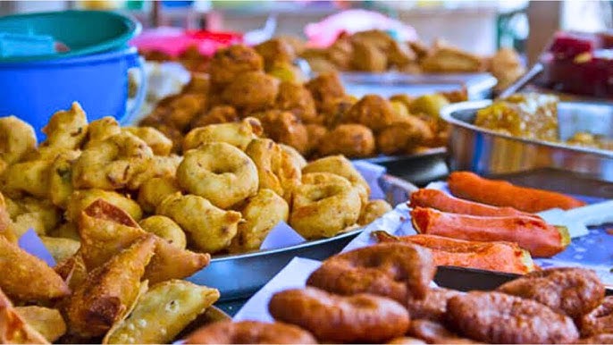 A table filled with some of the snacks on the Nigerian road trip menu.
