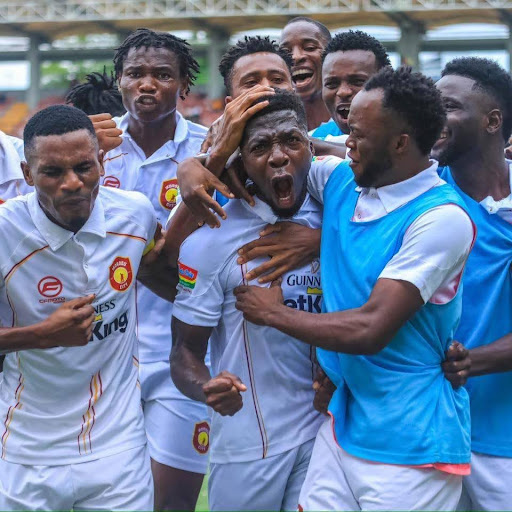 Players celebrating a goal during a league match with teammates

