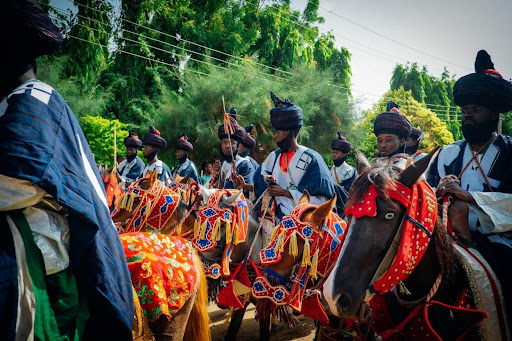 A picture of the Ilorin Durbar Festival, part of Nigeria’s Top Festive Parades and Cultural Festivals, showing horse riders and a community procession.
