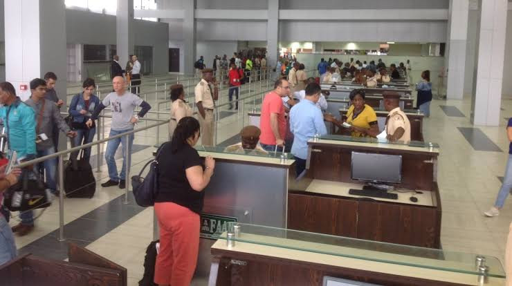  Foreign traveller talking to immigration in a Nigerian airport.