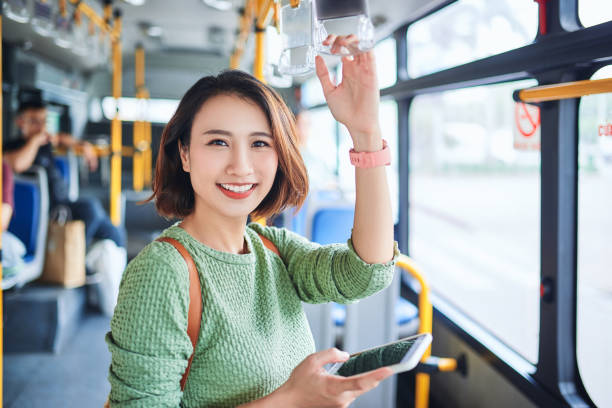  Happy Asian lady in a moving bus.