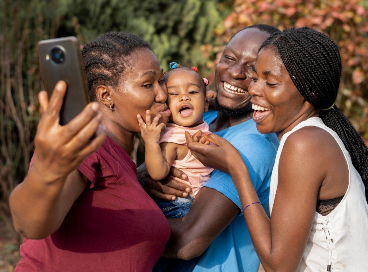  Things That Make Nigerians Feel at Home. A happy Nigerian family abroad taking a selfie.
