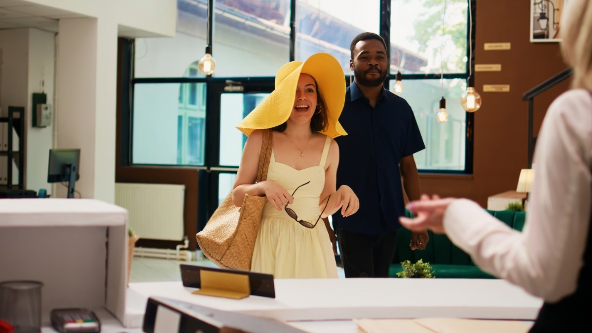 Nigerian man patiently listening to and guiding foreign visitors. 