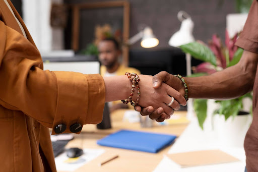 Nigerians Visiting Europe for the First Time: A Nigerian man shakes hands with a foreigner.
