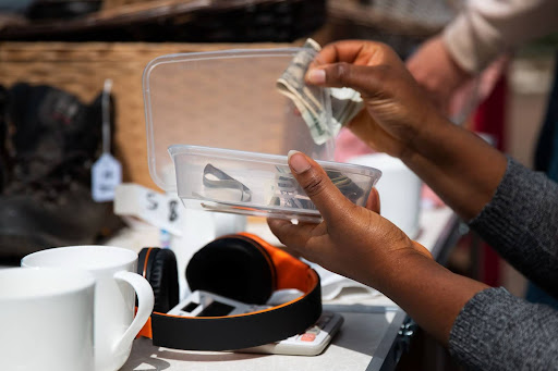 Nigerians Visiting Europe for the First Time: A black hand giving out money tip.

