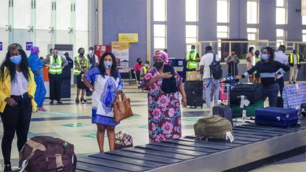  A picture of travellers waiting for their luggage in a Nigerian airport.