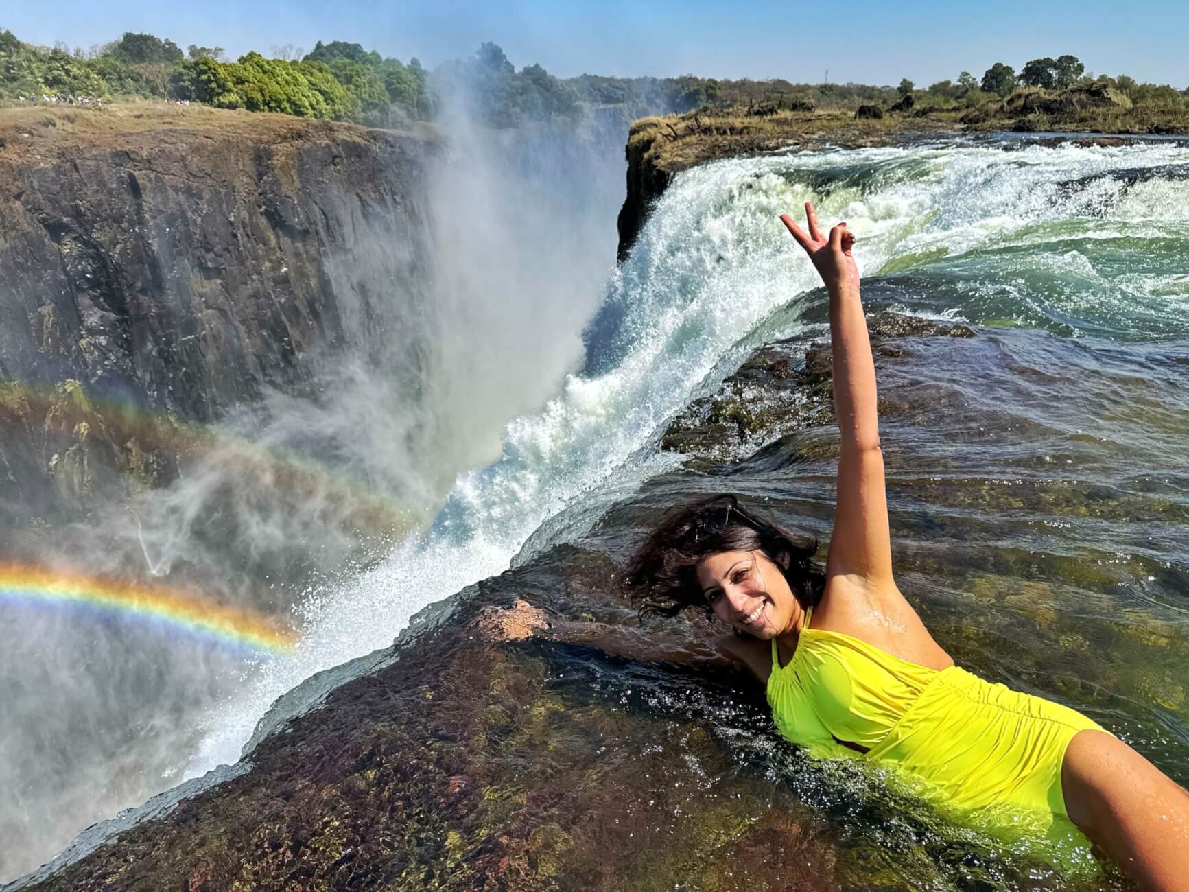 Tourist destinations in Africa: A tourist enjoying Victoria Falls.