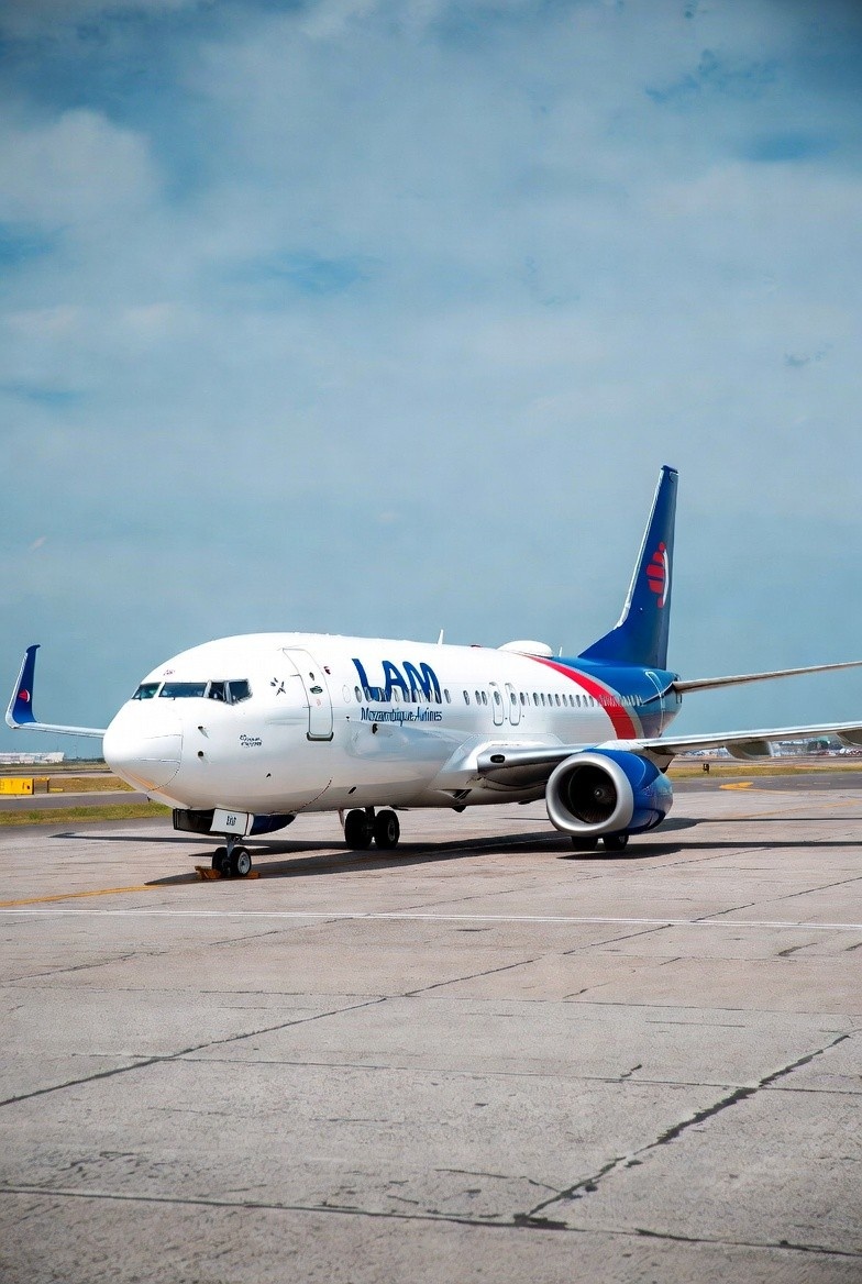 A LAM aircraft (Boeing 737 livery) on the tarmac at Maputo International Airport