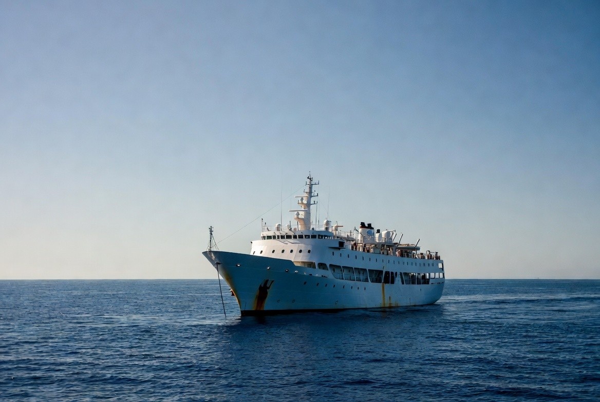A photograph of the Vasco da Gama vessel at sea, viewed from a wide deck perspective