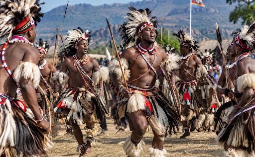  Men in ceremonial warrior dress sing and dance in a circle during the Incwala ceremony in Eswatini.
